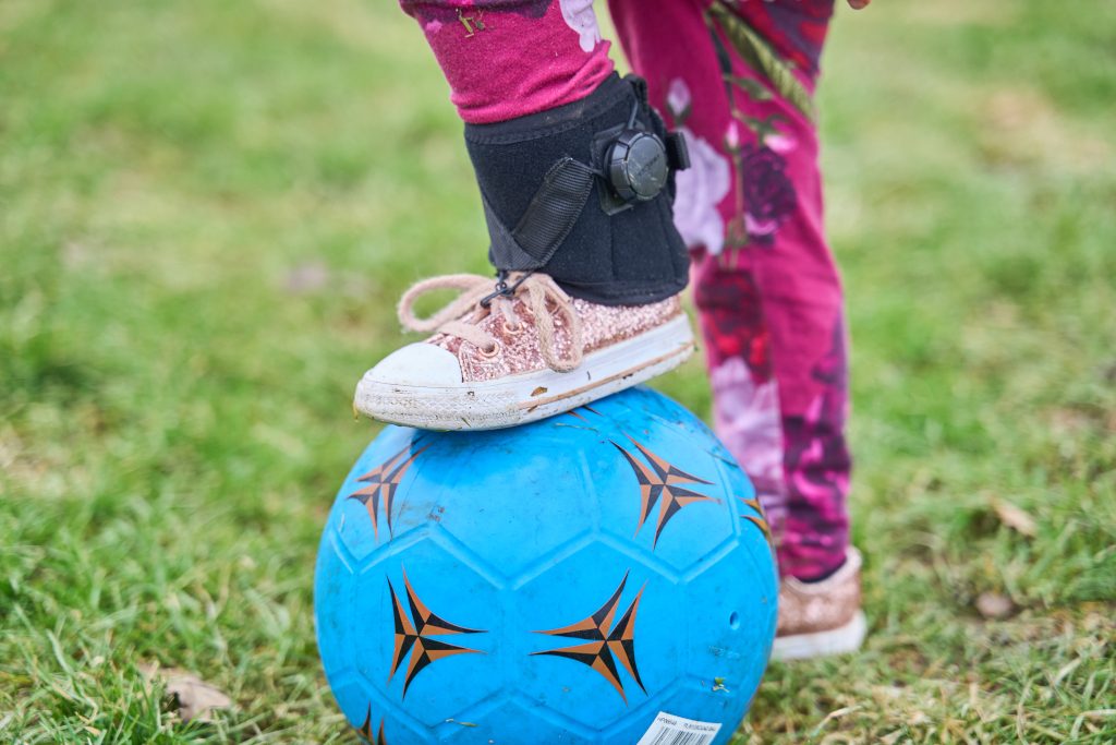 OrthoPed Foot Drop Splint shown during football activity
