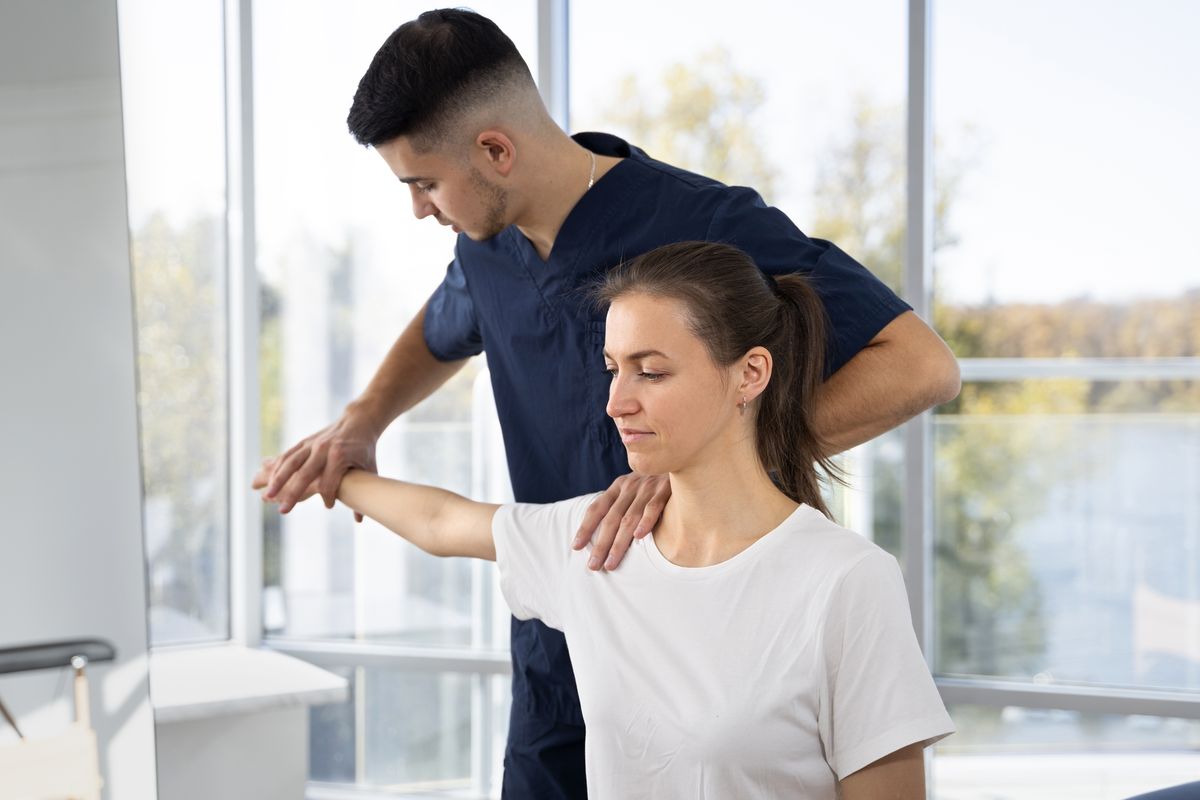 Physiotherapist treating a patient's shoulder